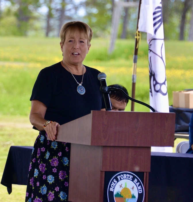 Cathy Chavers speaking at a podium. 