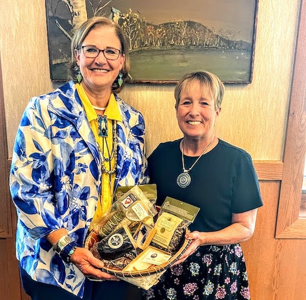 Kim Berns-Melhus, Minnesota State Director for The Conservation Fund (left), was gifted wild rice and other special items by Cathy Chavers (right) on behalf of the Bois Forte Band