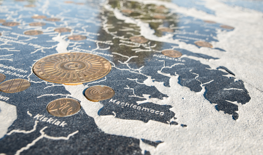 A closeup image of a map with collector's coin and the word, "Machicomoco" in focus