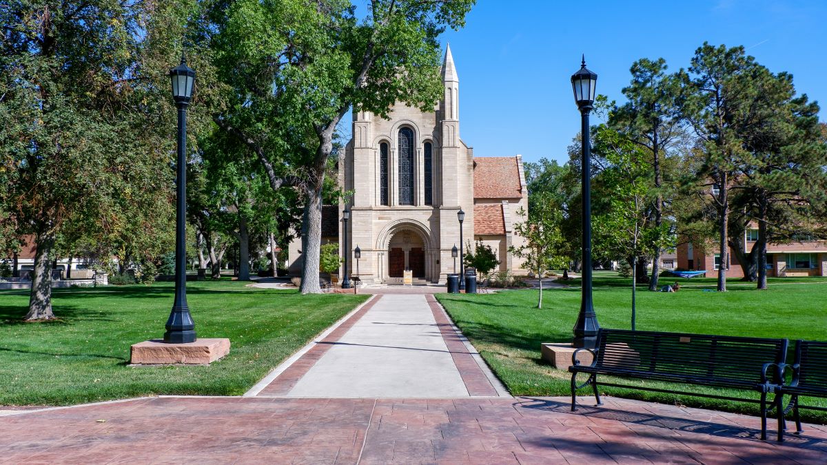 Campus building on a sunny day with green lawn