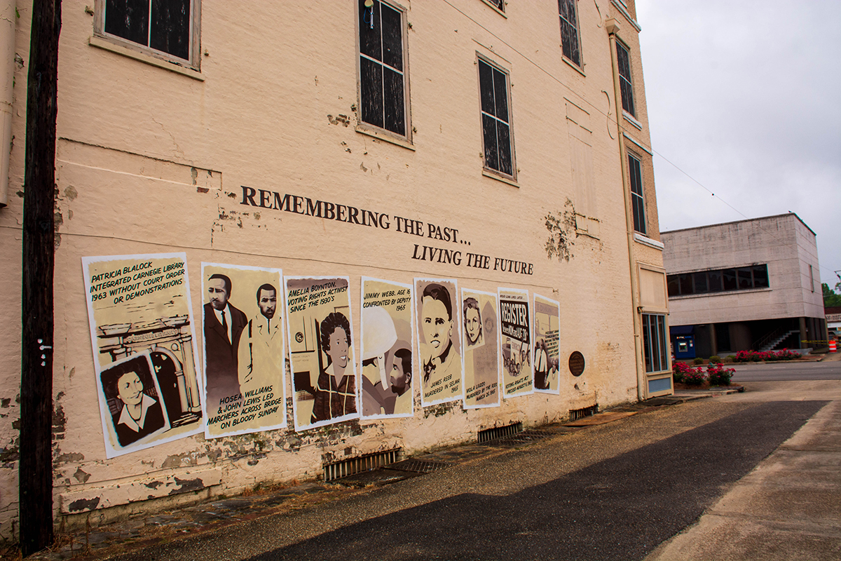 Street scene with a mural titled 