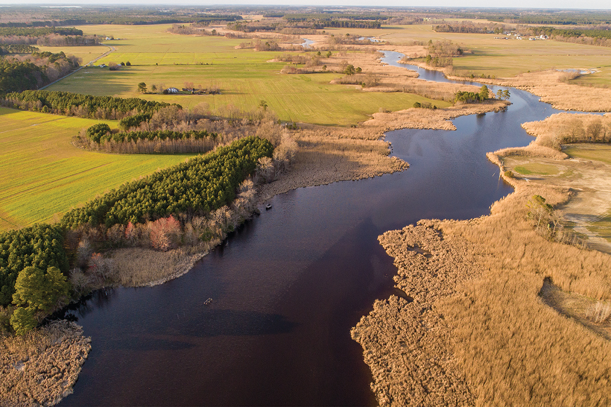 Wide, winding river with brown and green fields