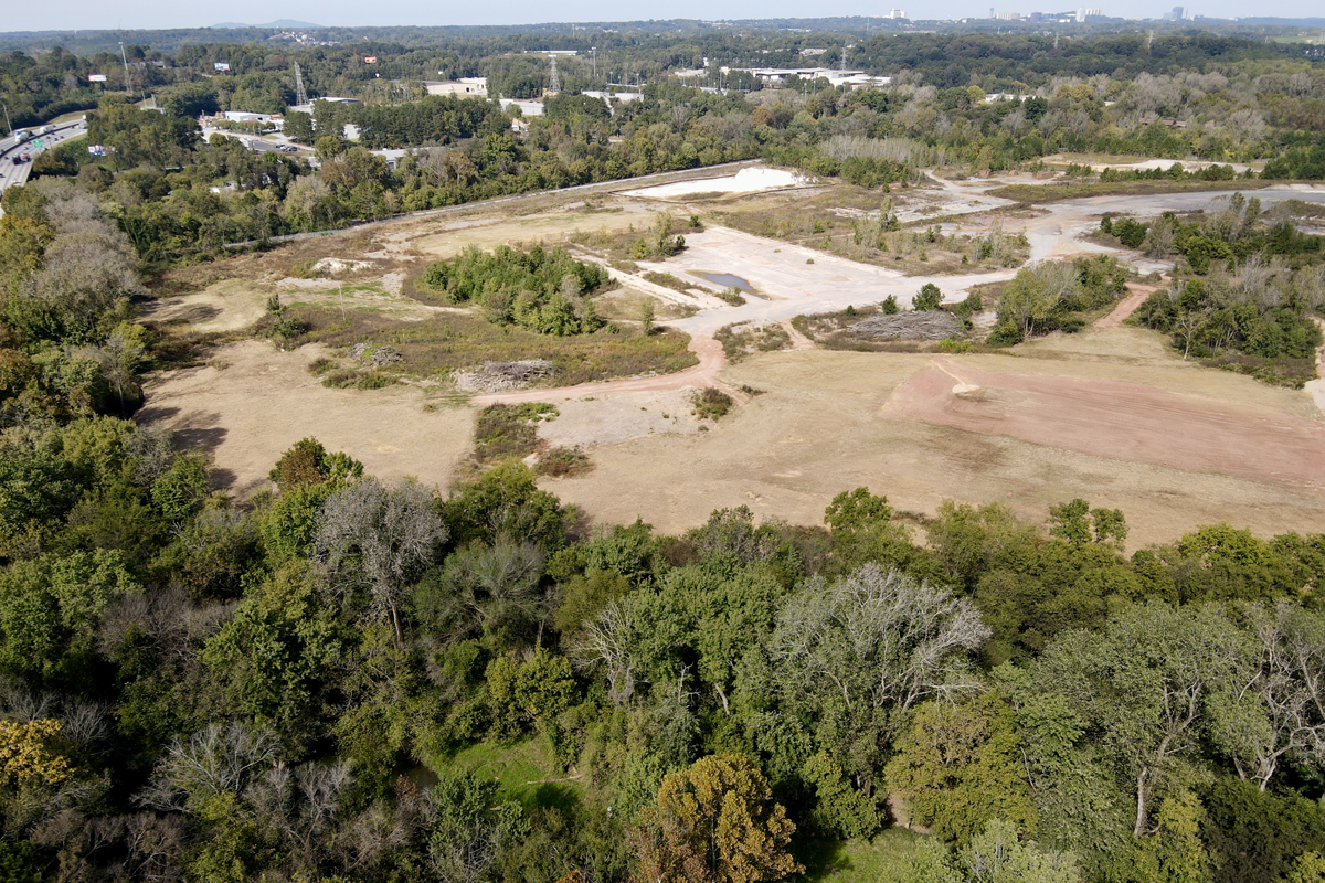 Large cleared field with trees surrounding it