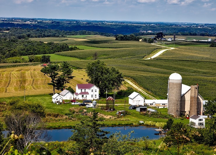 Farm buildings with rolling farm fields all around