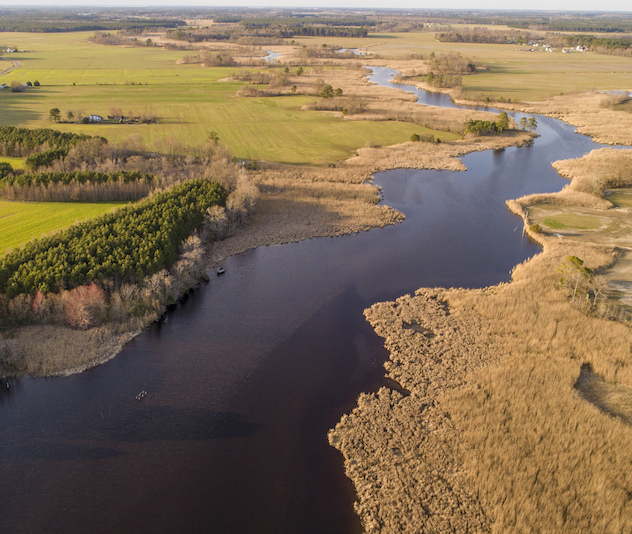 Winding river through fields