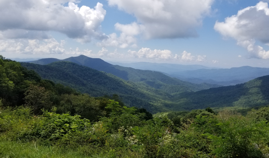 Panoramic view of Balsam Gap, North Carolina, with rolling hills and mountain ranges in the distance.